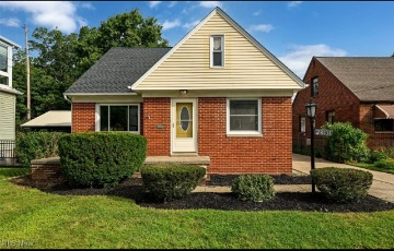 Brick Euclid, Ohio residence exterior with front lawn and landscaped shrubs